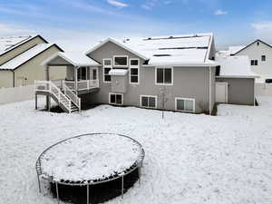 Snow covered house with a deck