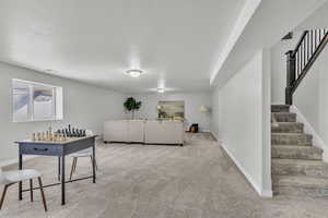 Living room with a textured ceiling and light carpet