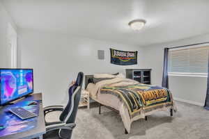 Carpeted bedroom featuring a textured ceiling