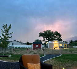 Yard at dusk with an outdoor structures