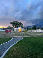 Fully fenced pasture with barn and chicken coop.