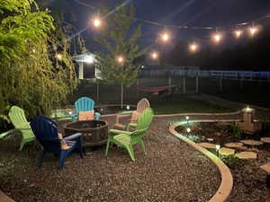 Yard at twilight featuring an outdoor fire pit