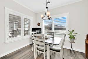 Dining area is light and bright with lovely chandelier.