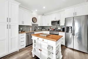 Timeless white kitchen cabinets, granite countertops and stylish tile backsplash.