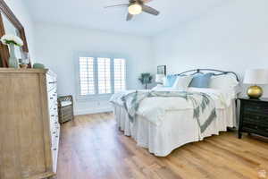 Bedroom featuring ceiling fan and light hardwood / wood-style flooring