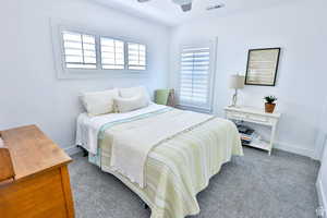 Bedroom featuring ceiling fan and dark carpet