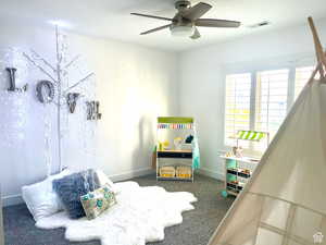 Carpeted bedroom with ceiling fan