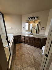 Full bathroom featuring tile patterned floors, vanity, separate shower and tub, and toilet