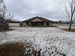 View of snow covered back of property