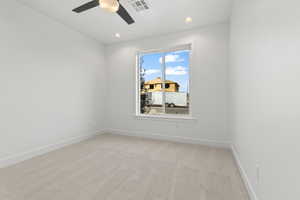 Carpeted spare room featuring ceiling fan