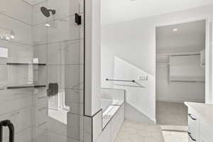 Bathroom with vanity and shower with separate bathtub