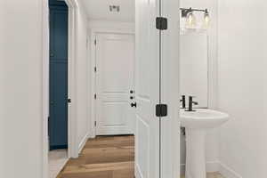 Bathroom featuring hardwood / wood-style floors and sink