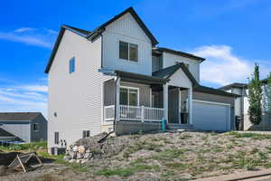 View of front of property featuring cooling unit and covered porch