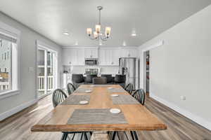 Dining space featuring light hardwood / wood-style flooring and a chandelier