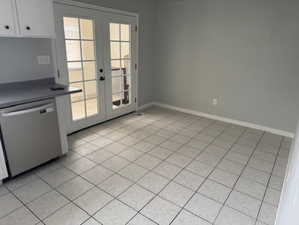 Entryway featuring french doors and light tile patterned flooring