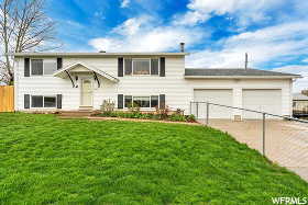 Bi-level home featuring a front yard and a garage