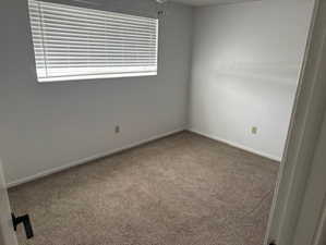 Empty room with carpet flooring