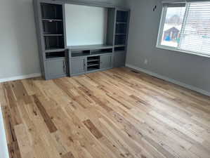 Unfurnished living room featuring light wood-type flooring