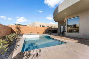 View of pool featuring a patio and a hot tub