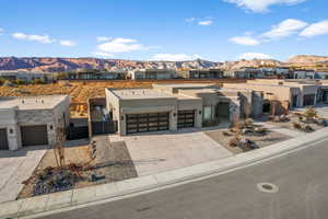 View of front of property with a mountain view and a garage