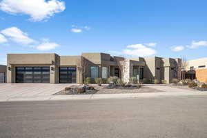 Pueblo revival-style home with a garage