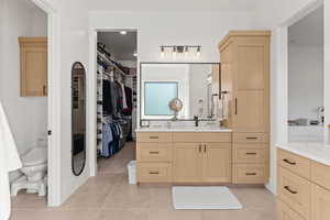 Bathroom with tile patterned floors, vanity, and toilet