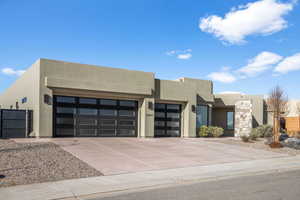 Pueblo-style house with a garage