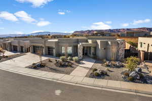 Pueblo-style home with a mountain view and a garage