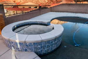 View of pool featuring an in ground hot tub