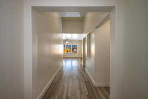 Hall with hardwood / wood-style flooring