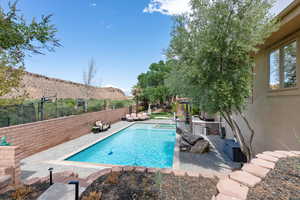 View of swimming pool featuring a mountain view and exterior kitchen