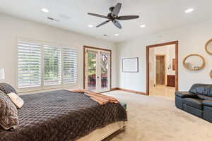 Carpeted bedroom featuring access to exterior, ceiling fan, and ensuite bathroom