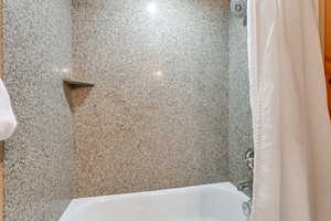 Bathroom featuring shower / bath combination with curtain