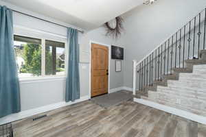 Foyer with hardwood / wood-style flooring