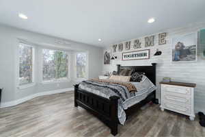 Bedroom with hardwood / wood-style flooring