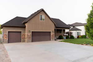 View of front of house featuring a front lawn and a garage