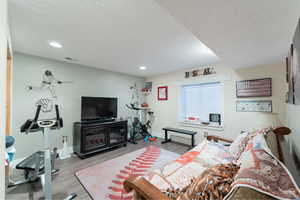 Living room with wood-type flooring and a textured ceiling