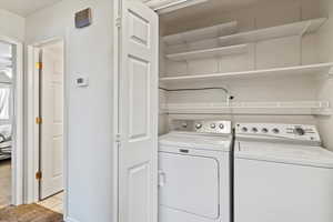 Washroom featuring light tile patterned floors and independent washer and dryer