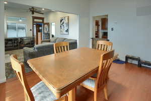 Dining area with ceiling fan and light wood-type flooring