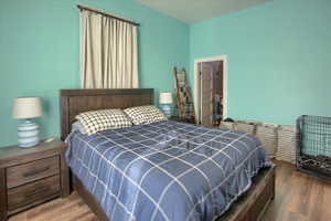 Bedroom with hardwood / wood-style floors