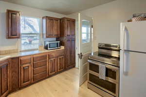 Kitchen featuring appliances with stainless steel finishes and light wood-type flooring