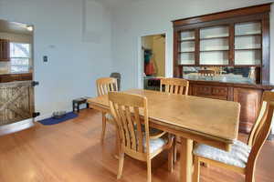 Dining space with light hardwood / wood-style flooring and ceiling fan