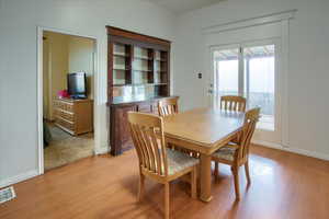 Dining area with light hardwood / wood-style floors