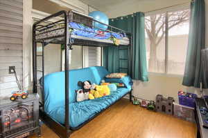 Bedroom featuring wood-type flooring and multiple windows