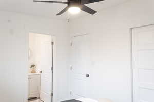 Unfurnished bedroom with ensuite bath and ceiling fan