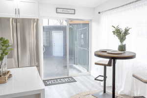 Bathroom featuring a healthy amount of sunlight and wood-type flooring