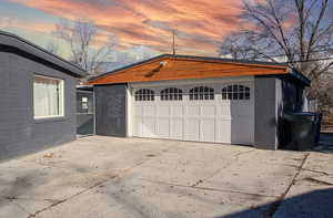 View of garage at dusk