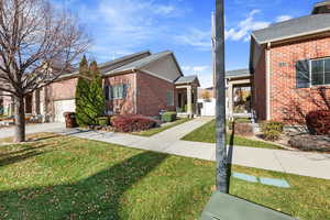 View of property exterior with a garage and a yard