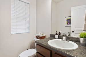 Bathroom featuring vanity and toilet