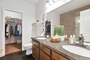 Bathroom featuring tile patterned flooring, vanity, and toilet